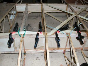 Notice the bungee cords keeping pressure to the side of the spar as well as the clamps. This is the bottom of the wing/spar.